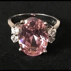 Beautiful Large Pink Oval Cz Gem (3+Carats) Stone With 2 Small Cz Gems On Each Side Tiny Heart Cutouts In The Silver Raised Base Setting New Never Worn Not Stamped Fine Quality No Tarnish Ring This Ring Is Gorgeous And Looks Much More Expensive Size 9 Includes A Tiny Organza Ribbon Bag For Gifting/Storage Please Ask About Discounts & Combined Shipping And Offers Are Welcome Oval Cubic Zirconia Rings, Ribbon Bag, Pink Gem, Gem Ring, Organza Ribbon, Tiny Heart, Gems Jewelry, Womens Jewelry Rings, Gift Bag