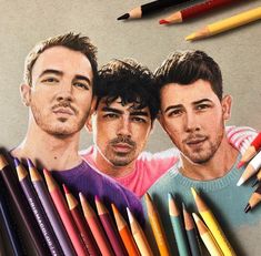 colored pencils next to an image of two men