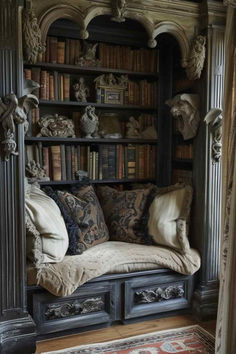 an old bookcase with many books and pillows on it in front of a window