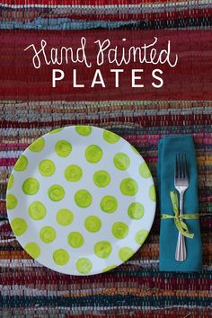 a plate with green polka dots on it next to a fork and napkin that says hand painted plates