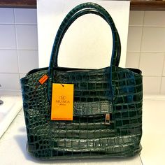 a green handbag sitting on top of a counter