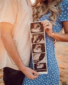 a man and woman standing next to each other holding an old photo in their hands