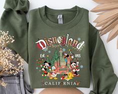 Celebrate the holidays with our Mickey and Friends Christmas Sweatshirt! This vintage Disneyland Christmas design is perfect for the whole family. Ideal for matching Christmas outfits or gifts, this cozy sweatshirt brings festive magic to your wardrobe. Shop now for holiday fun! ✔ Follow these steps to place an order and ensure the right color, size, and description: * Choose the desired size and color from the dropdown menu. * If customization is available, check the personalization box and pro Disneyland Hoodie, Christmas Disneyland, Mickey And Friends Christmas, Disneyland Sweatshirt, Disneyland Vintage, Disney Merry Christmas, Disneyland Christmas, Minnie Christmas, Mickey Shirt