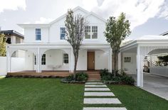 a white house with steps leading to the front door