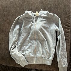 Grey Zip Up Hoodie With Pockets On The Front And A Hood Also. Zipper Works Perfectly And This Zip Up Was Never Worn. H&m Long Sleeve Sweatshirt For Spring, H&m Long Sleeve Sweatshirt For Winter, H&m Casual Winter Sweatshirt, Grey Zip Up Hoodie, Casual H&m Tops With Ribbed Cuffs, H&m Casual Tops With Ribbed Cuffs, Sporty H&m Hoodie For Fall, Casual Long-sleeved H&m Sweatshirt, Casual Long Sleeve H&m Sweatshirt