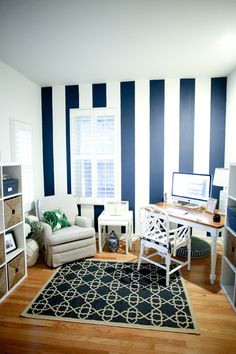 a living room with blue and white striped walls