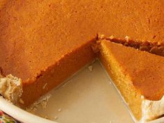 a pumpkin pie with one slice missing from it's crust and the rest cut out