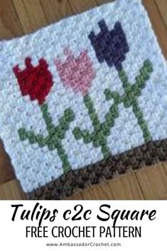 a crocheted square with tulips on it