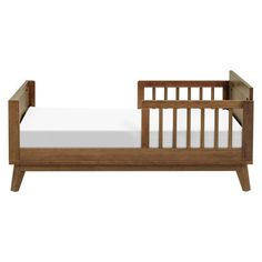 a small wooden bed with white sheets on the bottom and side rails, against a white background