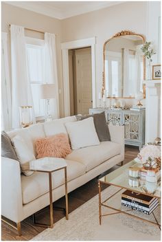 a living room filled with furniture and a mirror