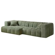 a large green couch with pillows on it's back and the seat folded out