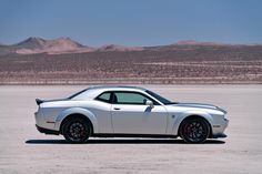 a white sports car parked in the middle of nowhere