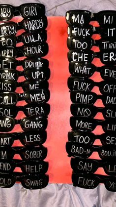 several pairs of glasses with words written on them are lined up against a red background