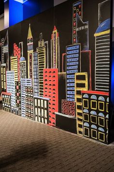 a large cityscape painted on the side of a wall in an office building