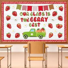 a green truck with strawberries on it is in front of a classroom wall that says our class is the berry best