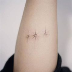 three star tattoos on the left side of the right arm and behind the elbow are small stars