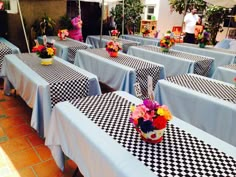 tables with checkered tablecloths and flowers on them