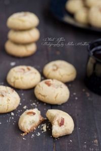 some cookies are sitting on a table with one broken in half and others scattered around