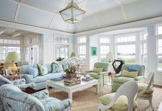 a living room filled with furniture and lots of windows