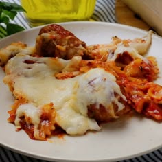 a white plate topped with lasagna and meatballs