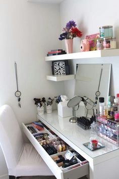 a white desk topped with lots of makeup and other items next to a mirror that says baires wood