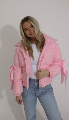 Stay warm and cute with our feeling cozy puffer jacket in baby pink. The bow detail adds a touch of sweetness. Available in brown too. (Babies will be the cutest thing in the winter with this jacket!) available for in store credit or exchange model wearing size small- true to size Pink Puffy Jacket Outfit, Pink Puffer Winter Outerwear, Pink Puffer Jacket Outfit, Puffy Jacket Outfit, Casual Luxury Pink Puffer Jacket, Baby Pink Puffer Jacket, Pink Winter Puffer Jacket With Pockets, Girly Winter Outfits, Luxury Pink Winter Puffer Jacket