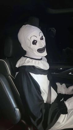 a person in a car wearing a ghost costume