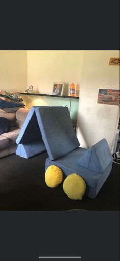 a child's play tent with two yellow balls on the floor