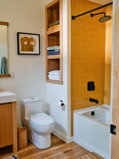 a bathroom with a toilet, sink and bathtub