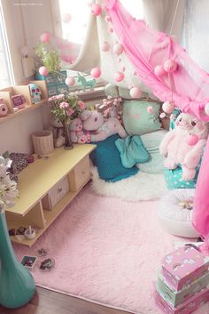 a room filled with lots of stuffed animals and pink decorations on the walls, windows, and rugs