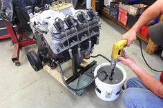 a man working on an engine in a garage