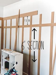 a room with several pieces of wood taped to the wall and labeled 6 section divider