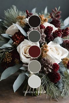 a bouquet with white roses, pine cones and greenery is arranged on a table