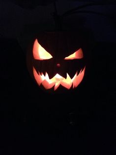 a carved jack o lantern in the dark