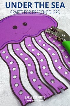 a pair of scissors cutting out paper with the words under the sea crafts for preschoolers