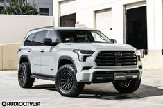 a white truck parked in front of a building