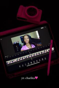 a tablet with an image of a woman on the screen and a pink pen next to it