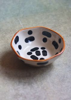 a black and white bowl sitting on top of a table