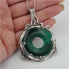 A HUGE 40mm **genuine** natural green agate stone held beautiful sculptural 925 sterling silver. This pendant come with matching solid silver chain. Material: Sterling Silveterling Silver Gemstone: 40mm Natural Green Agate Measurements: Pendant: 68mmx45mm Silver chain : 55cm (1 inch=2.54cm=25.4mm) Extra Care:Labeled and stamp 925We will send this jewelry in a gift box.Available in many other gemstones, please write to us if you wish for a different option.SHIPPING INFORMATION:Registered and insu Green Jewelry, Green Agate, 925 Silver Earrings, Art Large, Silver Pendants, Agate Pendant, Metal Jewelry, Jewelry Ideas, Sterling Silver Necklaces