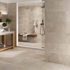 a bathroom with a sink, mirror and shower stall in it's center area