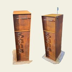 two wooden boxes with numbers on them sitting side by side in front of each other