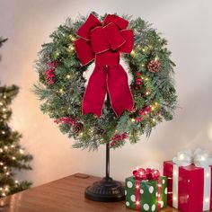 a christmas wreath and presents on a table