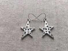 "Love these fun and whimsical star earrings! Made from allergy free, plated silver. They hang from silver plated simple hook earwires. The stars measure 1\" long by 3/4\" across. I have a matching necklace in my shop if you would like the whole set. https://www.etsy.com/listing/256162930/silver-star-necklace-silver-star-pendant?ref=shop_home_active_2 Thanks for stopping by and please take a look at the rest of my shop where you will find many more beautiful adornments. Tiger Flower Jewelry - Ins Celestial Star-shaped Hypoallergenic Earrings, Celestial Star Hypoallergenic Earrings, Silver Star-shaped Earrings, Big Star Earrings, Tiger Flower, Star Dangle Earrings, Silver Star Earrings, Celestial Earrings, Star Necklace Silver