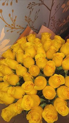 a bouquet of yellow roses sitting on top of a table