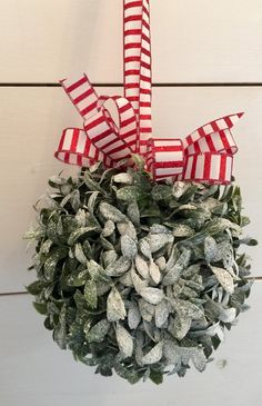 a red and white wreath hanging on the wall