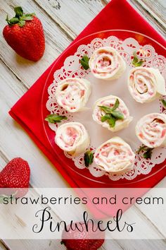 strawberries and cream pinwheels on a red plate next to some strawberries