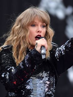 taylor swift performs on stage at the concert