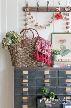 an old filing cabinet is decorated with flowers and other things to decorate on it's side