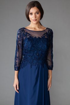 a woman wearing a long blue dress with sheer sleeves and an embellished top