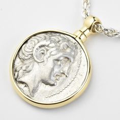 This silver coin was minted in Thrace, Greece between 306 and 281 BCE The face of the coin features a Diademed head of the deified Alexander the Great, and the rear features Athena, seated, holding a winged Nike The coin frame was handmade, in house, in 14k yellow gold, with a swivel bail A certificate of authenticity accompanies your purchase Goldmakers Jewelry Mission Statement Goldmakers Jewelry creates and curates a comprehensive selection of artfully designed hand-crafted jewelry out of our Mythological Silver Jewelry With Coin Pendant, Silver Mythological Jewelry With Coin Pendant, Luxury Silver Medallion Coin Necklace, Luxury Silver Coin Necklace With Medallion, Luxury Silver Coin Necklace With Coin Pendant, Luxury Silver Coin Necklace With Pendant, Luxury Engraved Coin Necklace, Luxury Silver Engraved Coin Necklace, Luxury Engraved Silver Coin Necklace